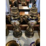 A pair of Vienna porcelain vases, decorated with classical panels, with looped gilt goat head mask