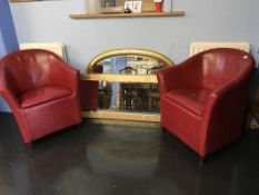 A pair of red tub chairs