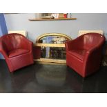 A pair of red tub chairs