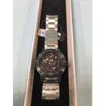 A boxed Weird Ape men's kolt black bezel skeleton face watch with steel strap, (as new), including