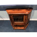 A small side cabinet, with grilled door