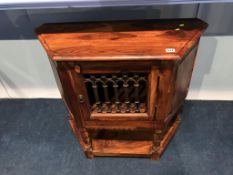 A small side cabinet, with grilled door
