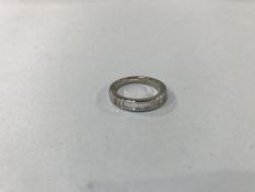 An 18ct white gold half hoop eternity ring, with eleven baguette diamonds