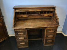 A 1930's oak tambour fronted desk