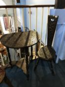 A carved oak chair and triangular oak occasional table