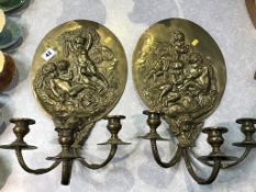 A pair of oval embossed brass two branch wall sconces, 40 x 24cm