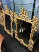 An impressive pair of Chippendale style ornate wall mirrors, 144 x 100cm