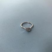 An 18ct white gold diamond ring, with diamond surround on plain band, 0.33ct