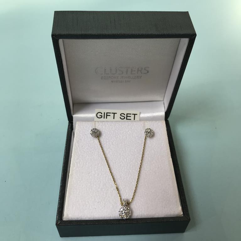 A 9ct gold two tone and diamond necklace and earring set