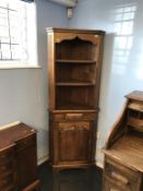 An oak corner cabinet