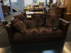 A maroon two seater sofa