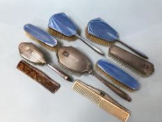 A silver enamel brush set and a silver brush set