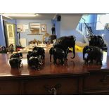 A collection of carved wood elephants