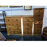 A large pine chest of drawers, a narrow pine chest of drawers and a pair of pine bedside chests