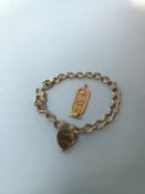A 9ct gold bracelet, 12g, and a yellow metal Egyptian style fob, 2.5g