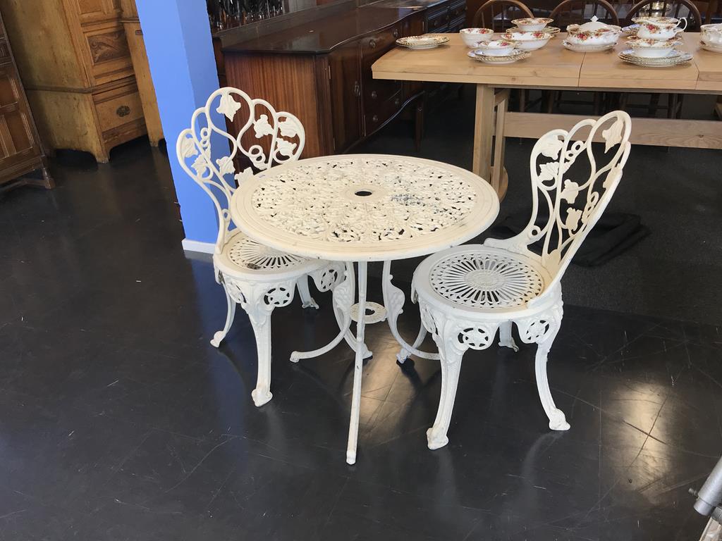 A cast garden table and two chairs
