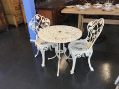 A cast garden table and two chairs