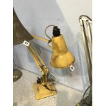 A yellow Herbert Terry and Sons angle poise lamp