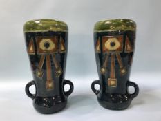 A pair of Art Pottery two handled tapering vases, decorated with geometric designs, 35cm height