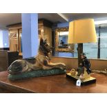 A plaster model of an Alsatian dog and a table lamp