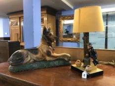 A plaster model of an Alsatian dog and a table lamp