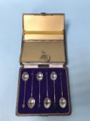 A silver cigarette case, silver coffee spoons and a brooch