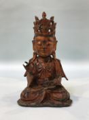A lacquered metalware seated Guanyln, 22cm high