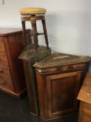 Two oak hanging corner cabinets and a revolving piano stool