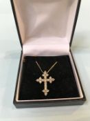 An 18ct gold crucifix, with 1ct diamonds and chain