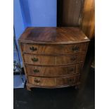 A bow front chest of drawers