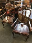 A pair of mahogany armchairs, with leather embossed seat pads
