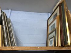 A shelf of pictures and prints
