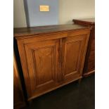 An oak two door cupboard