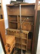 A teak bookcase, pine plate rack and a lamp