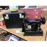 A cased Singer 222k sewing machine
