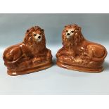 A pair of Staffordshire lions and two prints