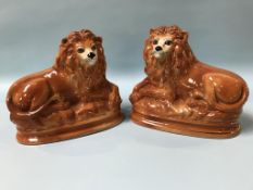 A pair of Staffordshire lions and two prints