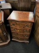 A reproduction burr walnut serpentine front chest of drawers
