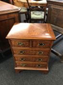 A mini reproduction walnut chest of drawers