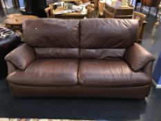 A brown leather two seater sofa