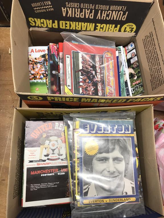 Two boxes of football programmes