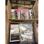 Two boxes of football programmes