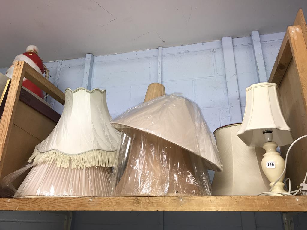 A quantity of lampshades and a lamp