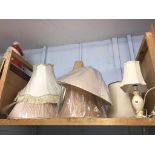 A quantity of lampshades and a lamp