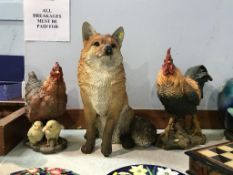 A model of a fox and two cockerels