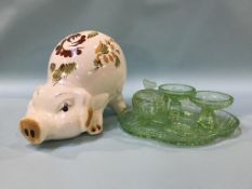 A green glass dressing table set and a large pottery pig money box