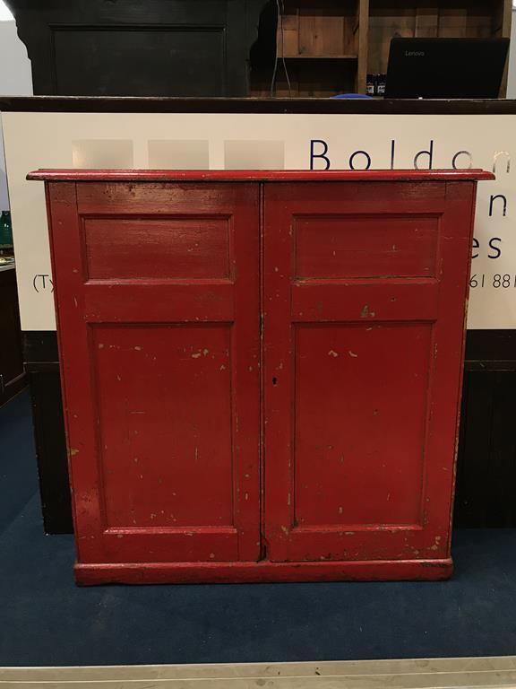 A Victorian red painted pine two door cabinet