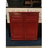 A Victorian red painted pine two door cabinet