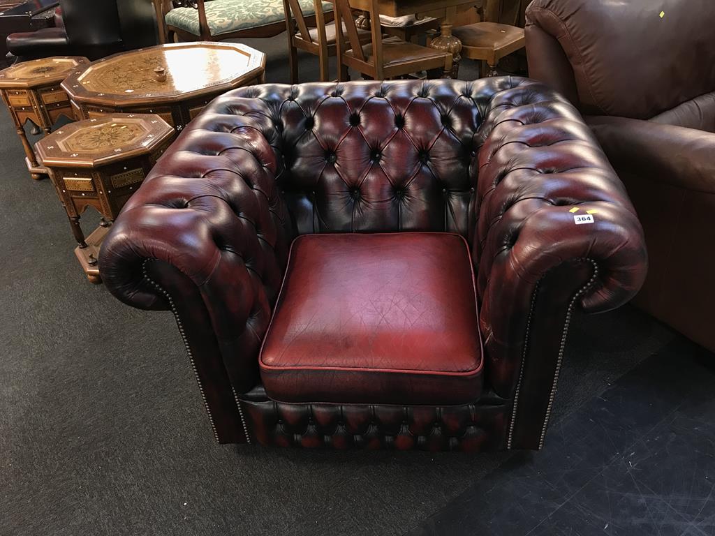 A maroon leather Chesterfield club chair