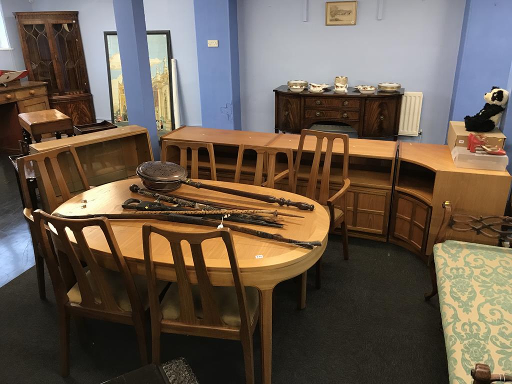 A teak extending dining table and six chairs, three matching units, together with an oak sliding